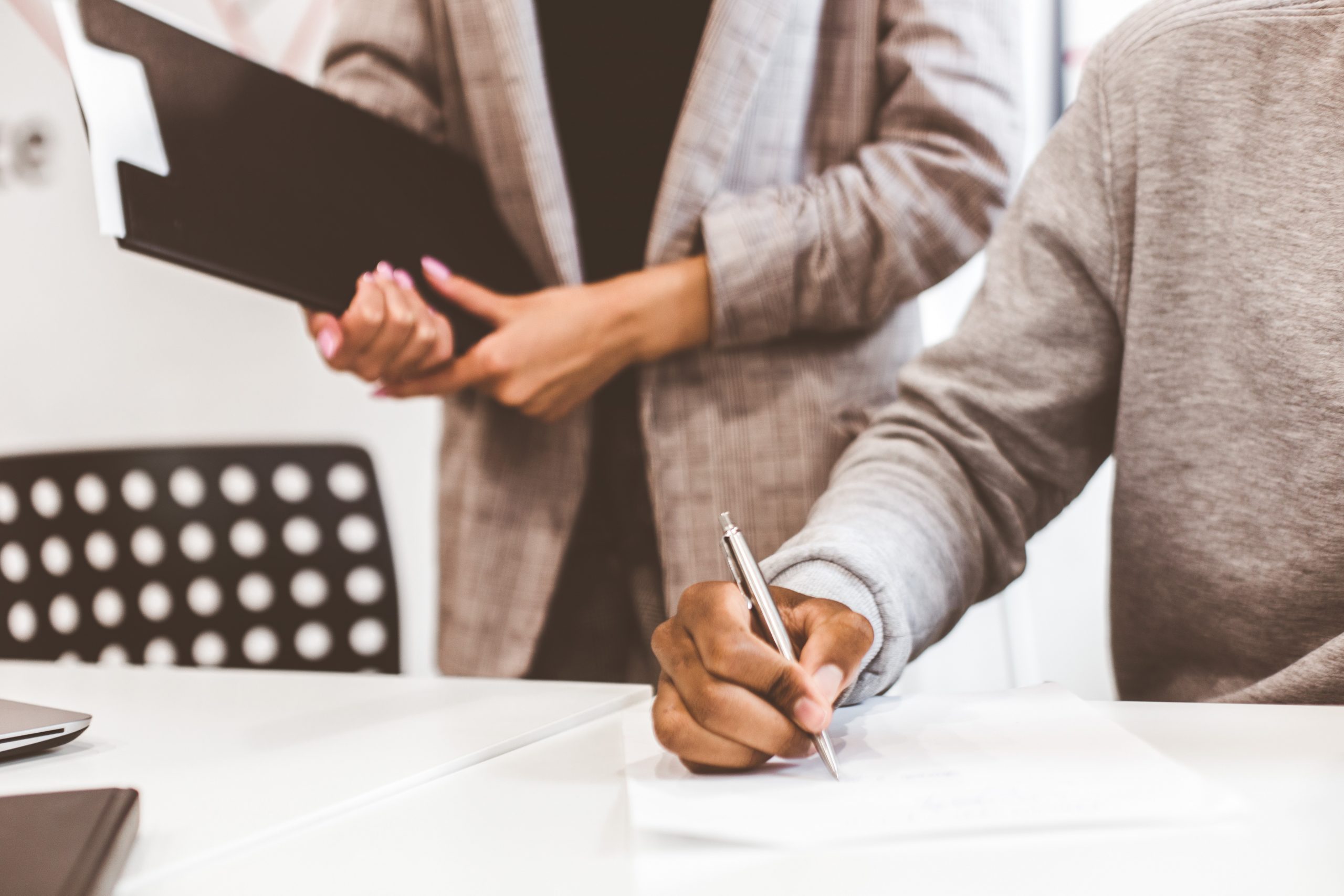 Man signing contract, black man hand putting signature on official document, biracial clients customers couple make purchase or sign prenuptial agreement concept